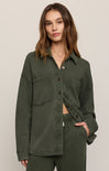 Woman wearing a green jacket on a plain background