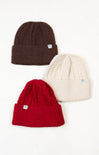 Three knit beanie hats in brown, red, and beige on a white background