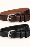 Two leather belts, one dark brown and one black, each with a polished silver-tone metal buckle, arranged on a clean off-white background.