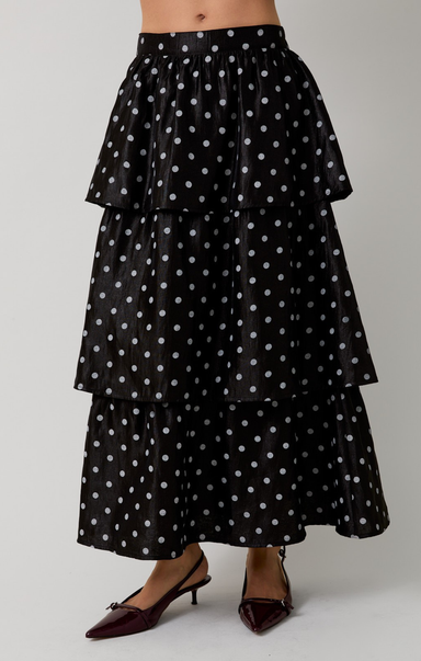 Black tiered polka dot skirt on a plain background