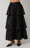 Black tiered polka dot skirt on a plain background