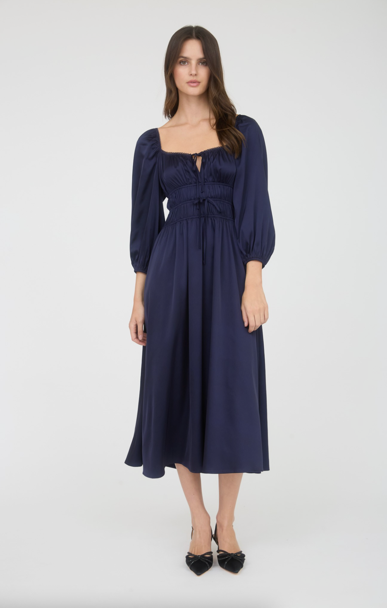 Woman wearing a navy blue dress on a white background