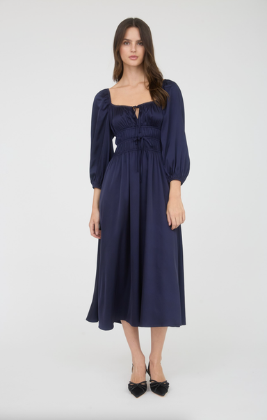 Woman wearing a navy blue dress on a white background