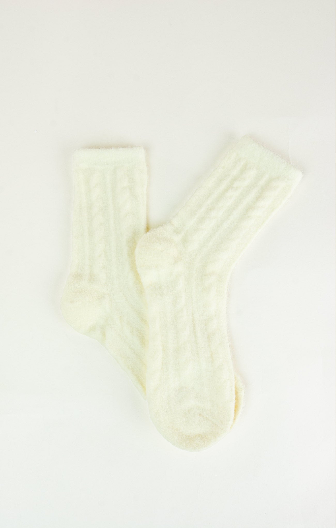 Pair of cream-colored socks on a white background