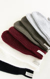 Set of knit beanies in various colors on a white background