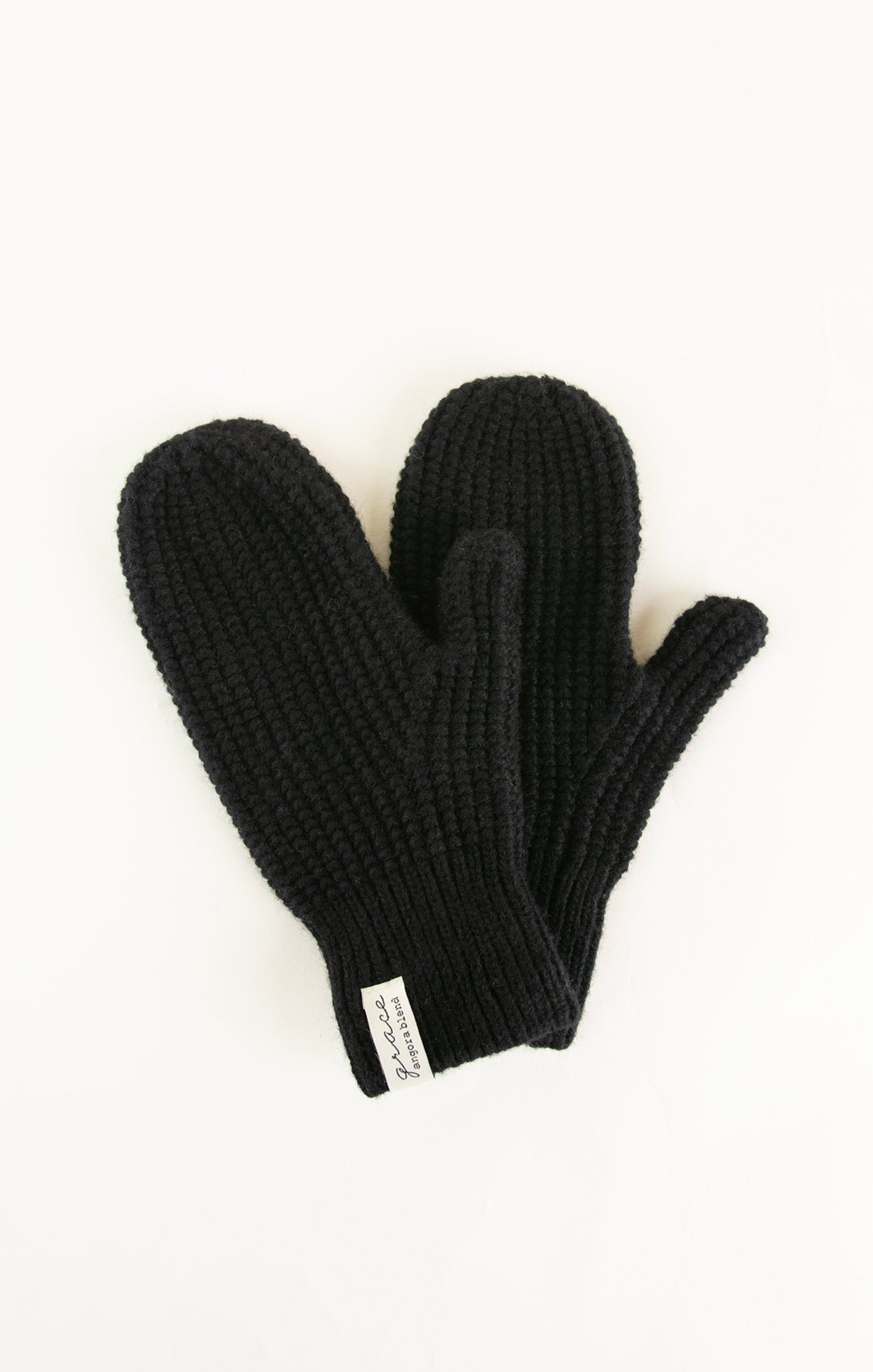 Black knit gloves on a white background