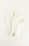 Pair of white knit mittens on a light beige background