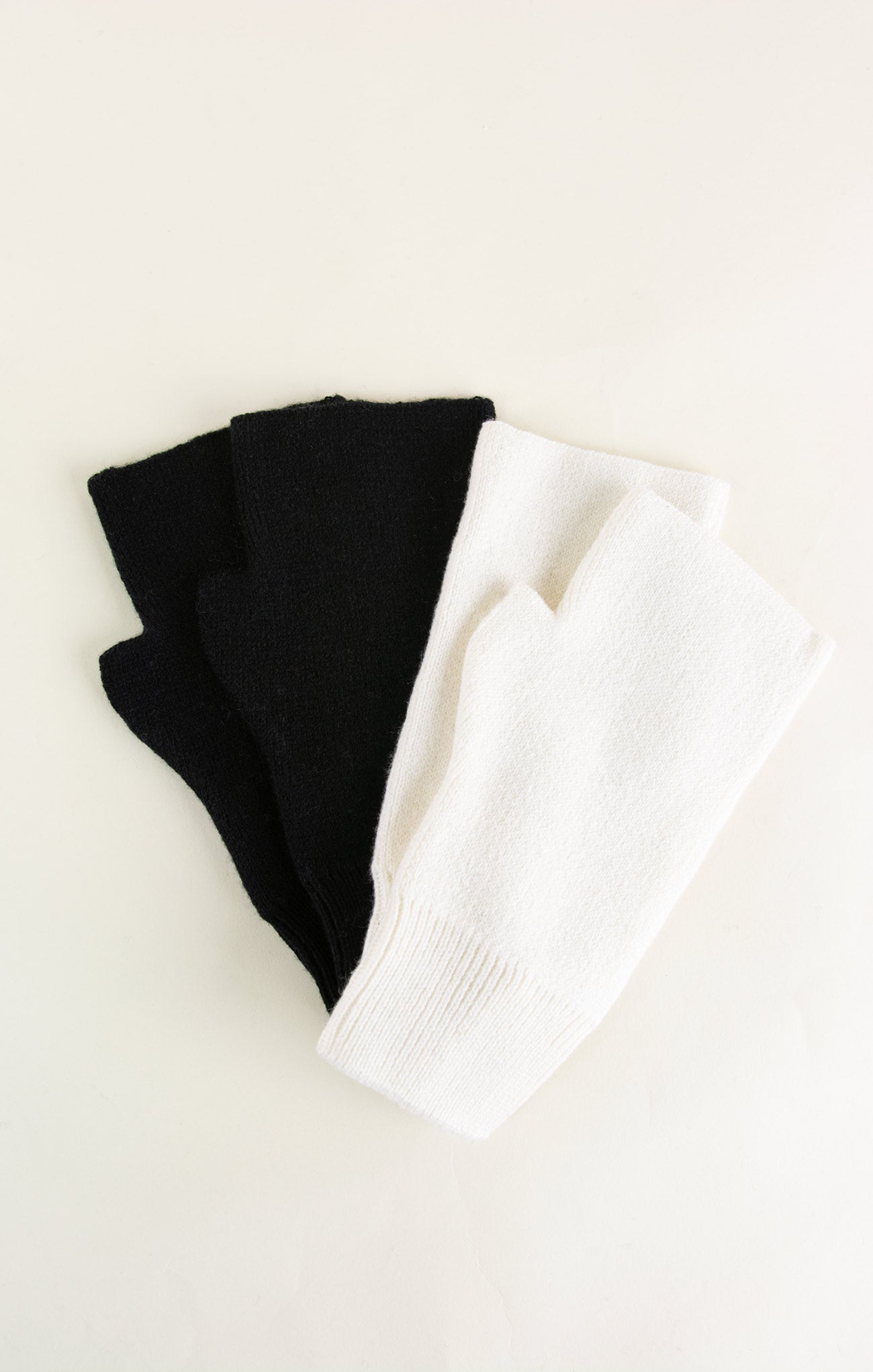 Black and white folded fabric on a light beige background