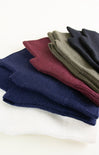 Stack of folded socks in various colors on a white background