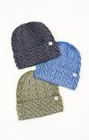Three knit beanie hats in gray, blue, and green on a white background