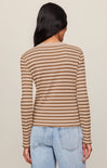 A woman shown from the back wearing a beige and brown horizontally striped long-sleeve knit top with light blue jeans, set against a plain beige studio background.