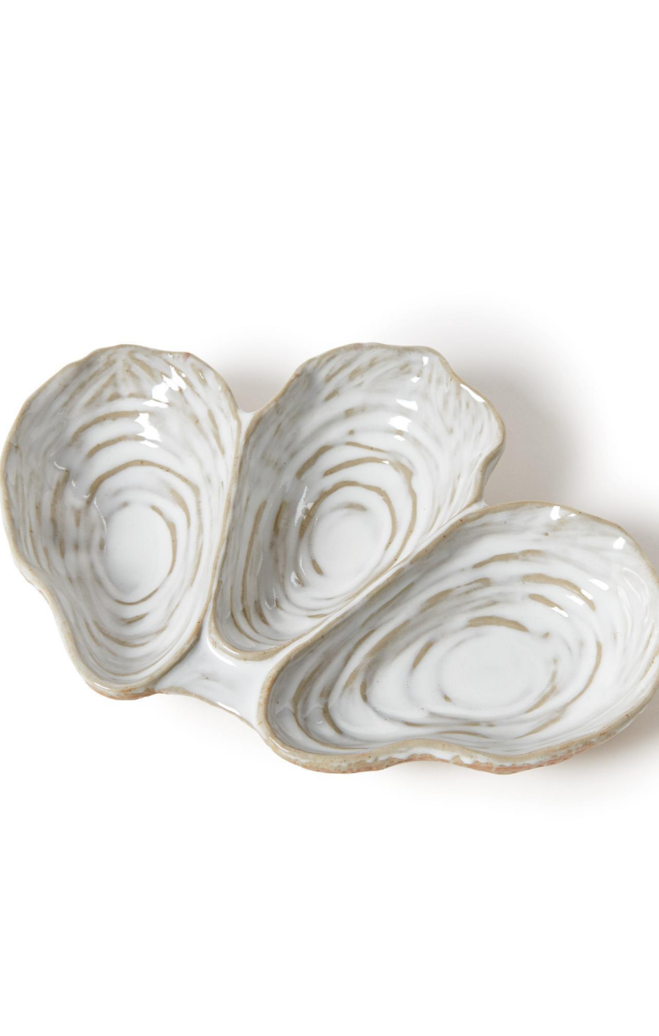 Three oyster-shaped ceramic dishes on a white background