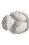 Decorative white shell-shaped dish with gold accents on a white background