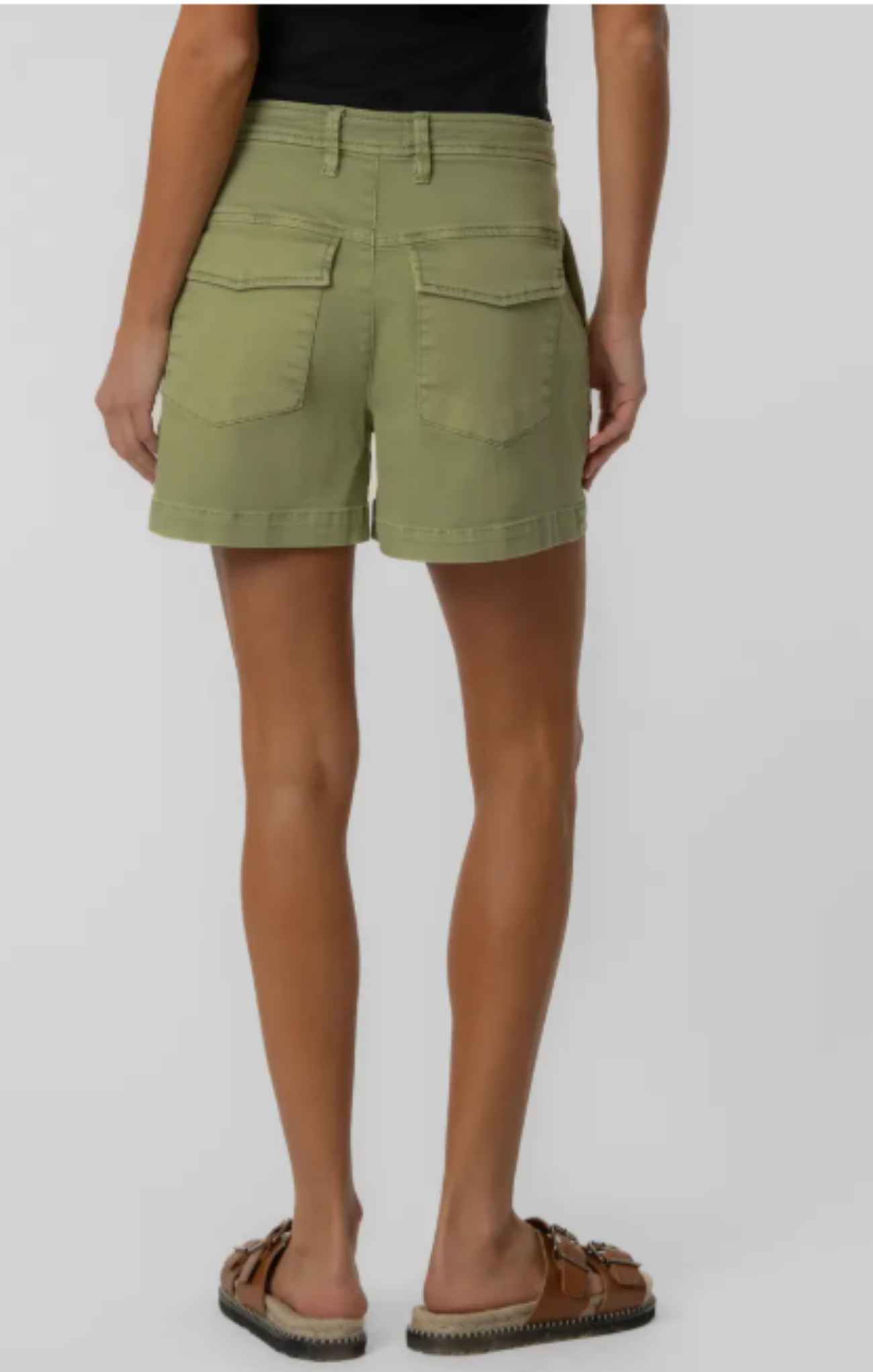 Person wearing olive green shorts on a plain background