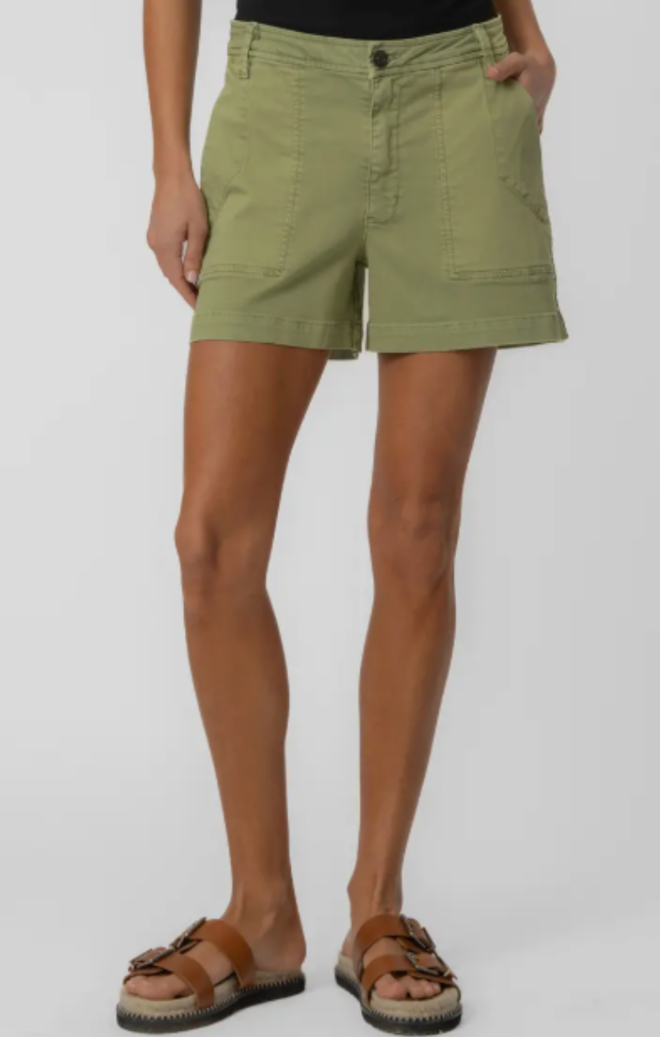 Person wearing green shorts on a white background