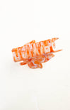 Orange and white hair clip on a white background