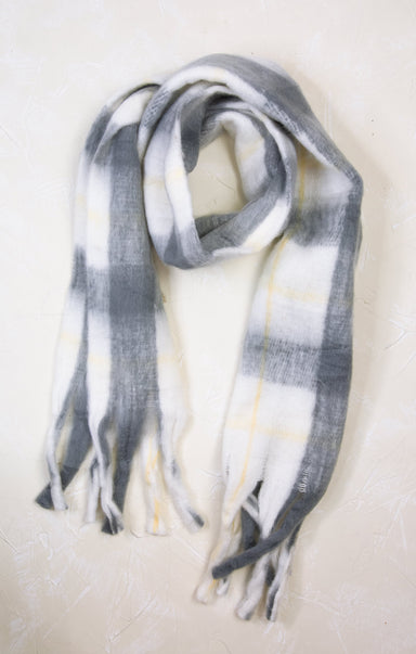 Plaid scarf with gray, white, and yellow pattern on a light background