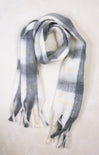 Plaid scarf with gray, white, and yellow pattern on a light background