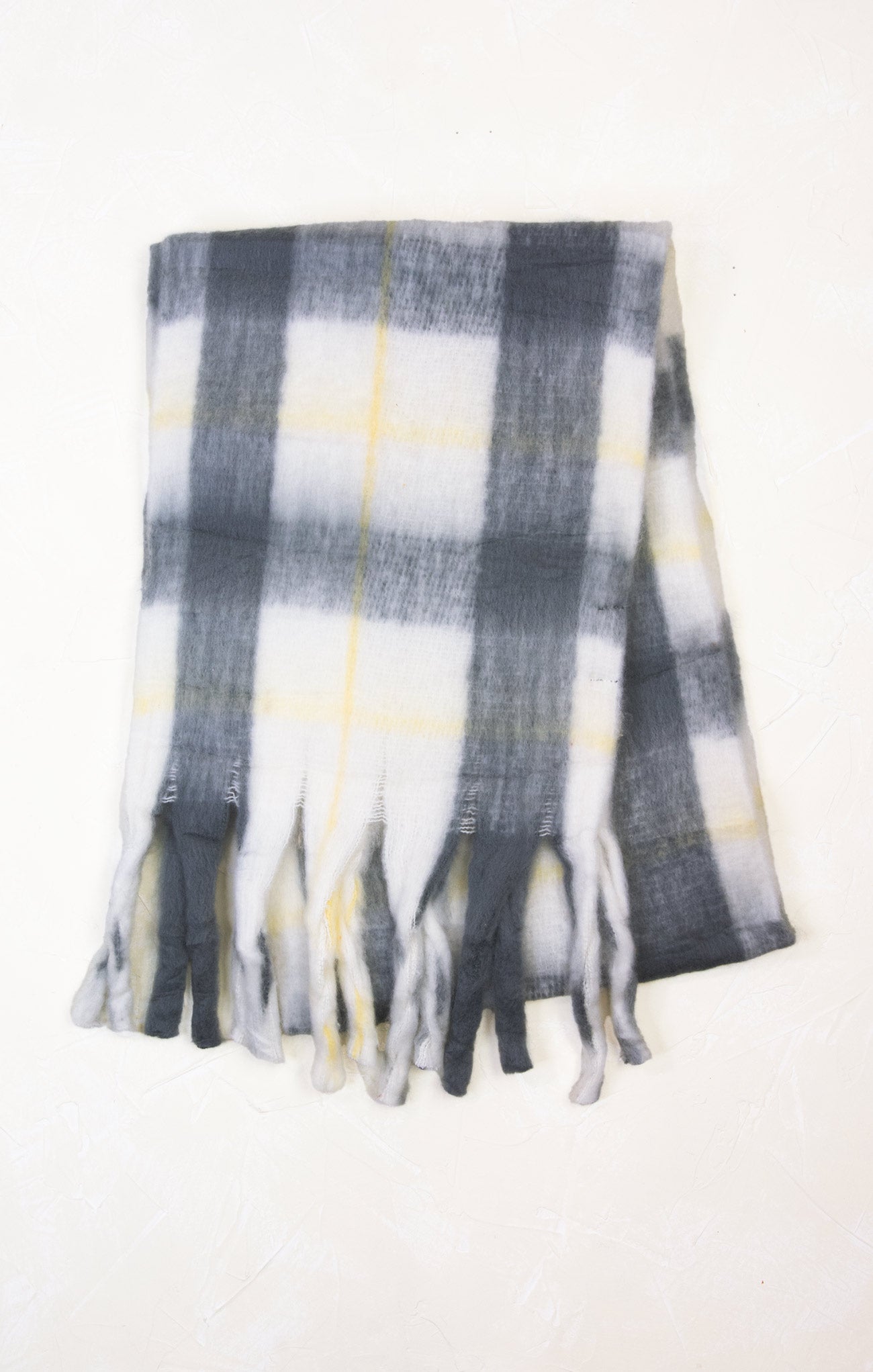 Plaid scarf with tassels on a white background