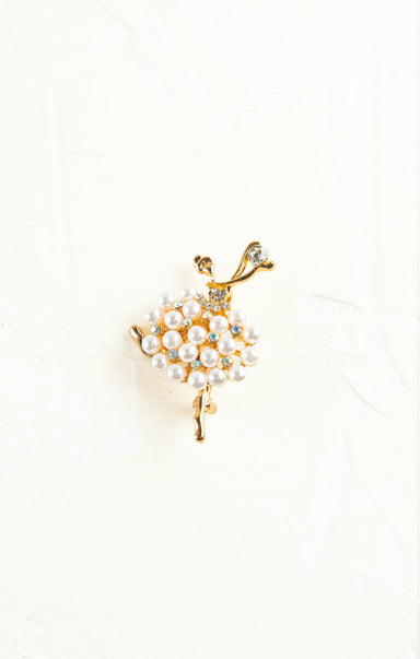 Ballerina-shaped brooch with pearl skirt on a white background