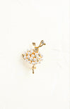Ballerina-shaped brooch with pearl skirt on a white background