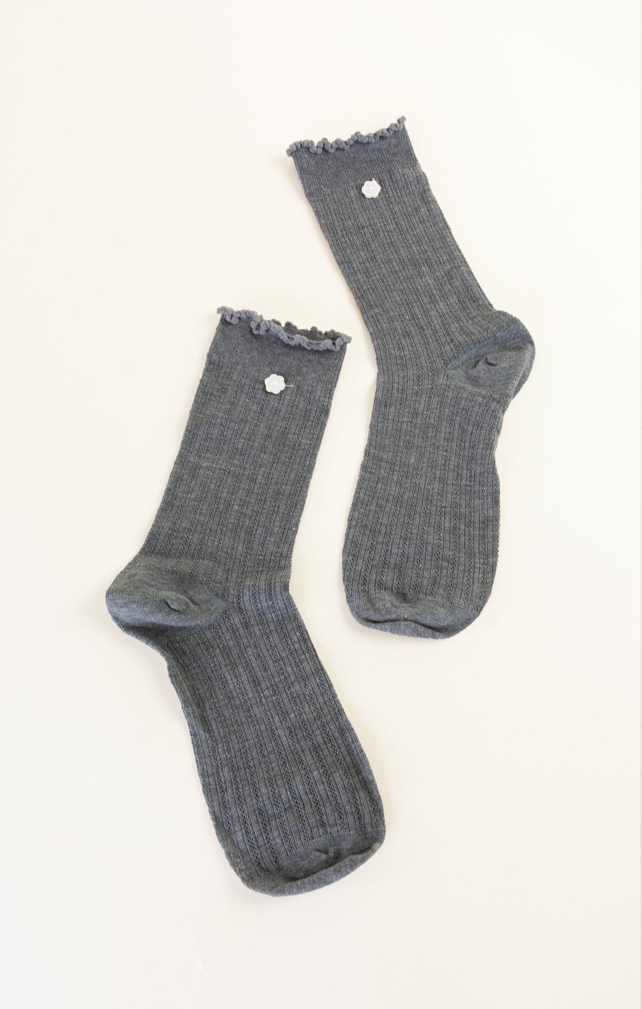 Pair of gray socks with lace trim on a white background