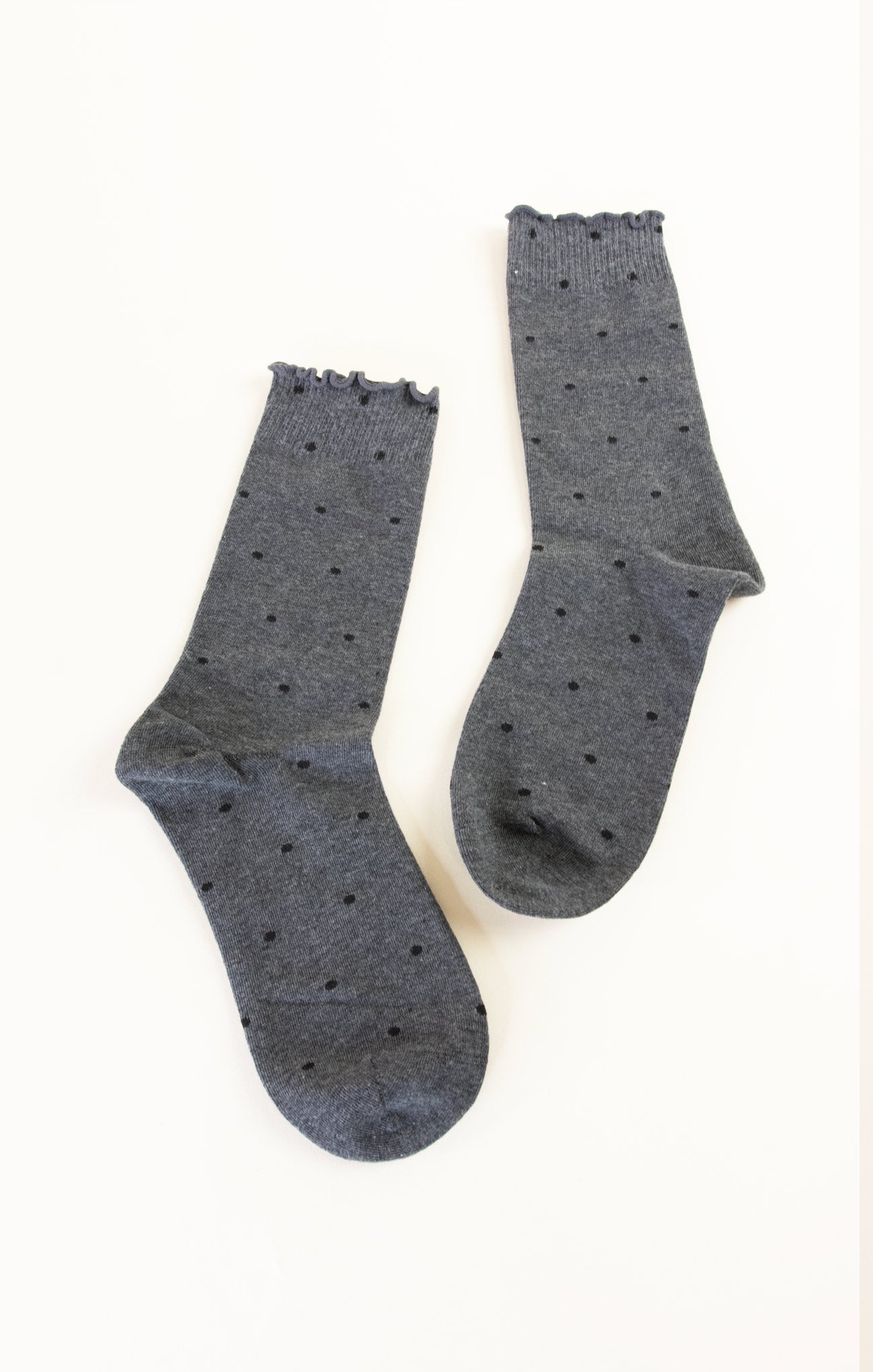 Pair of gray socks with black dots on a white background