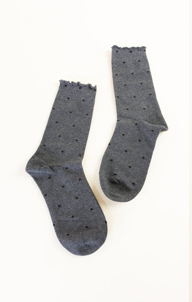Pair of gray socks with black dots on a white background