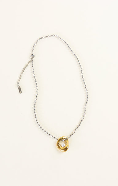 Necklace with a gold and silver pendant on a white background