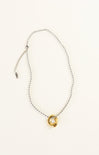 Necklace with a gold and silver pendant on a white background