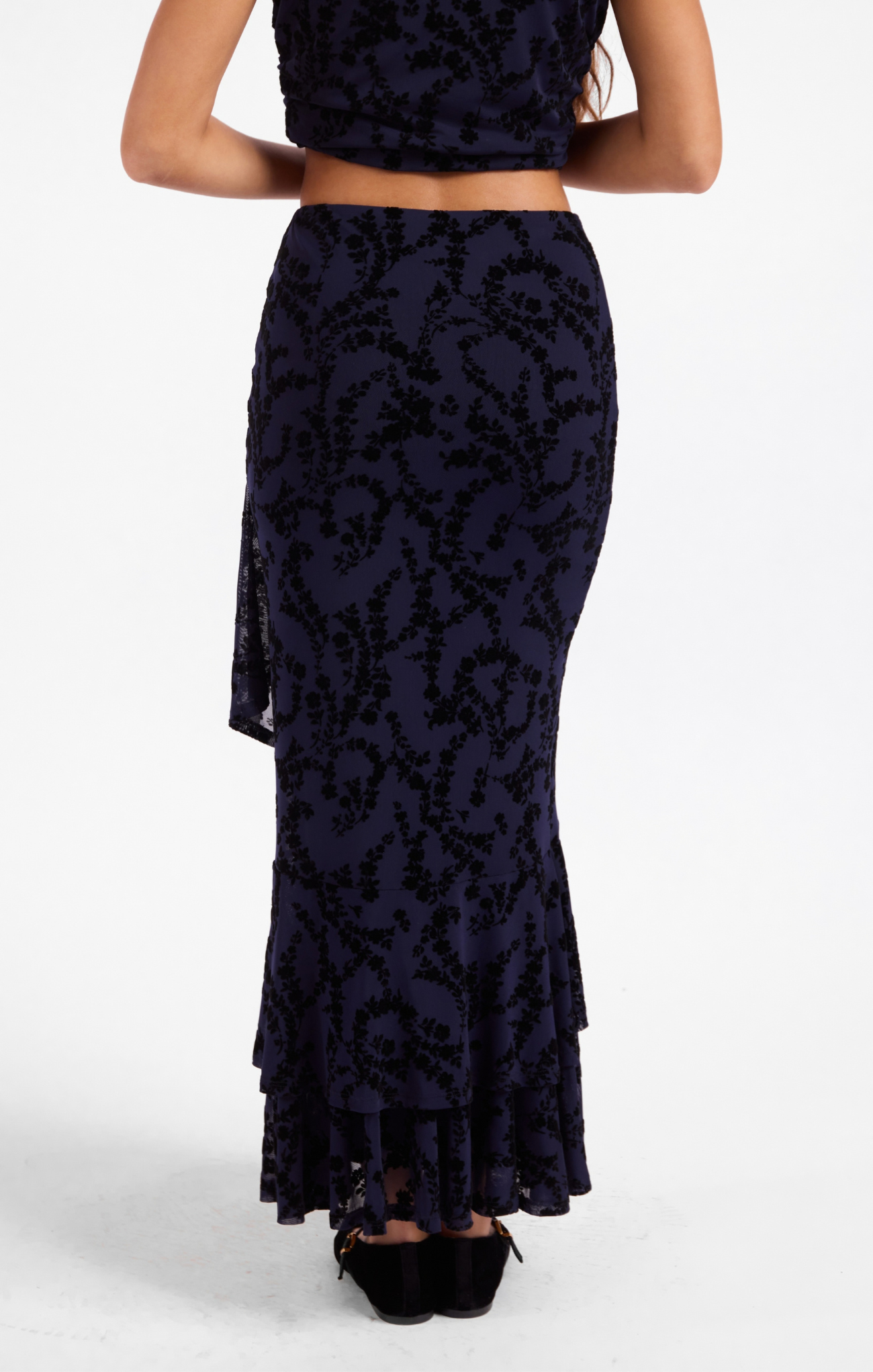 Navy lace two-piece outfit with a top and long skirt on a white background