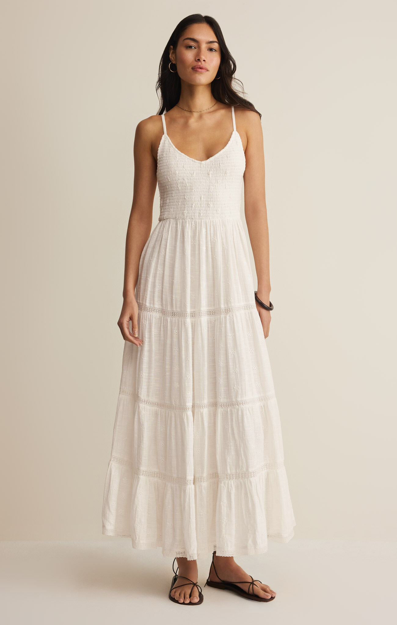 Woman wearing a white dress against a plain background