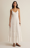 Woman wearing a white dress against a plain background