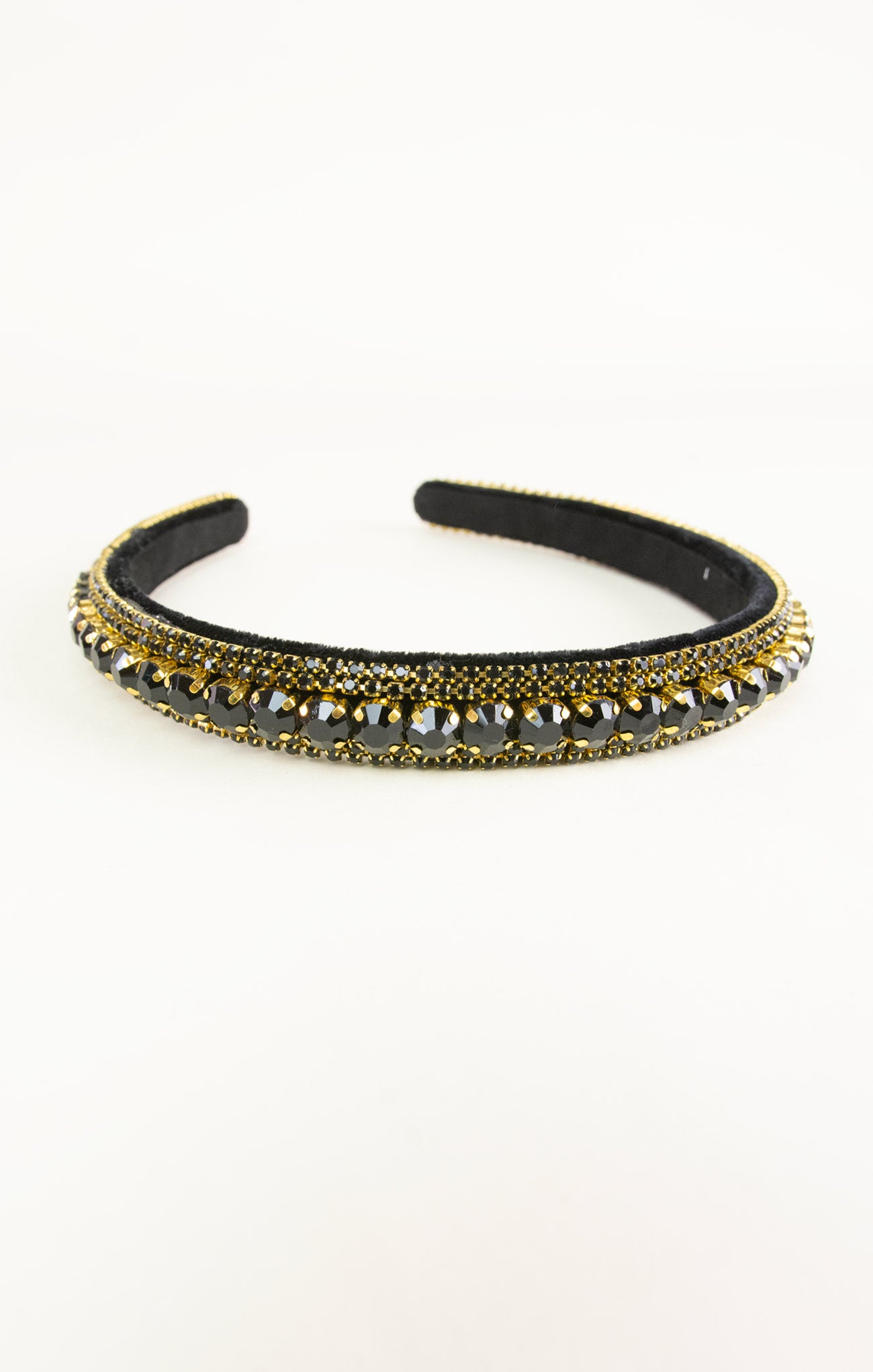 Black headband with gold and silver embellishments on a white background