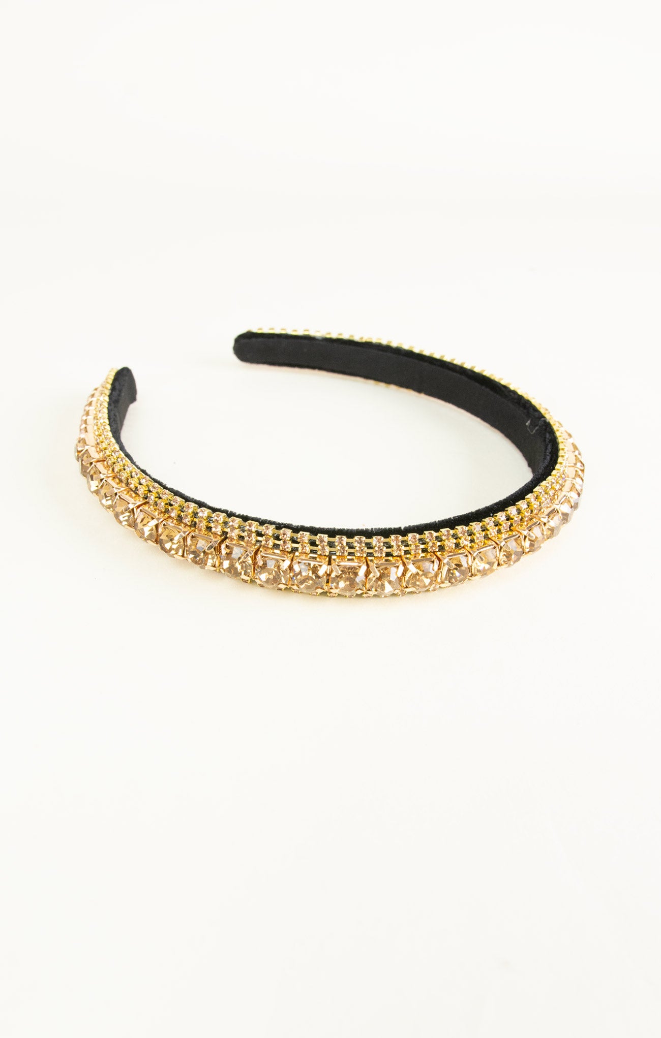 Gold headband with black interior on a white background