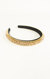 Gold headband with black interior on a white background