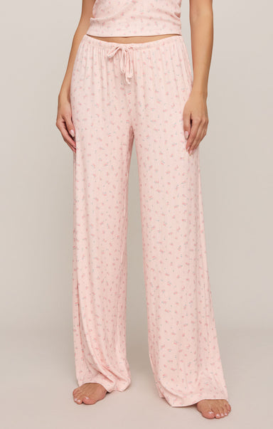 Pink pajama set with drawstring pants on a plain background