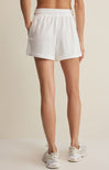 Person wearing white shorts on a plain background