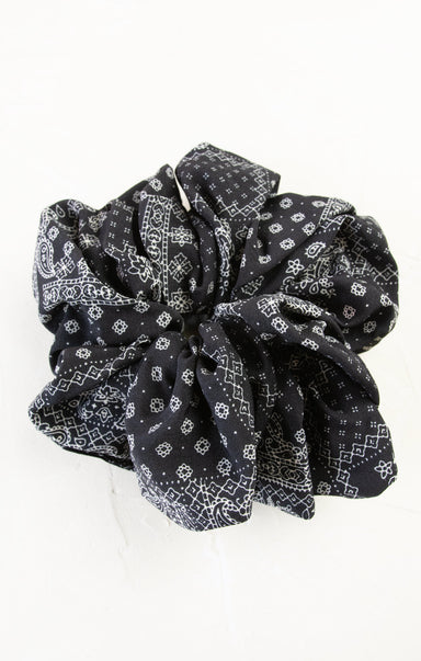 Black patterned hair scrunchies on a white background