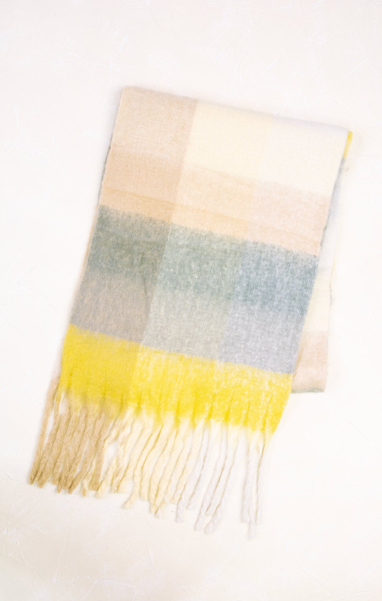 Plaid scarf with yellow fringe on a white background