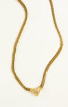 chunky gold chain with gold heart and gem inside heart