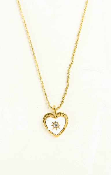Gold heart-shaped necklace with a diamond on a white background