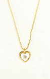 Gold heart-shaped necklace with a diamond on a white background