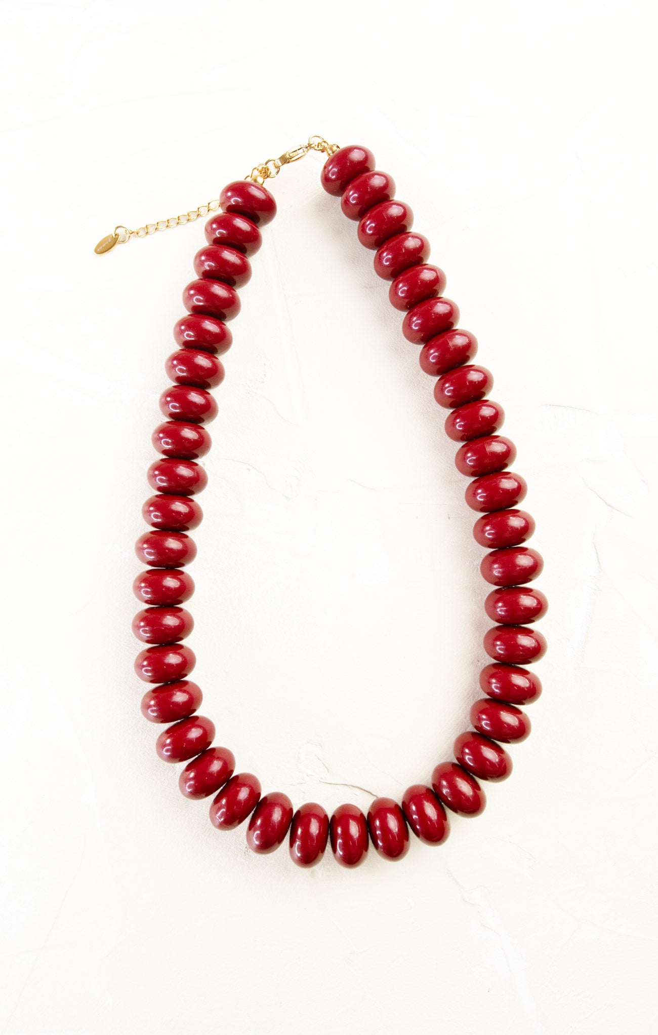 Red beaded necklace on a white background