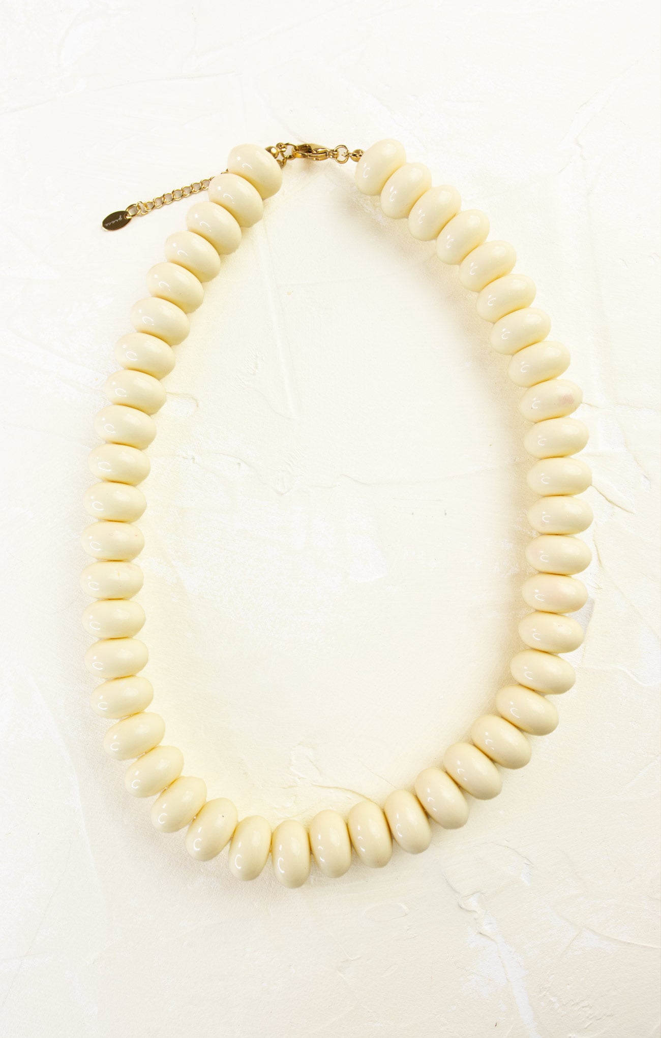 White beaded necklace on a white background