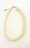 White beaded necklace on a white background
