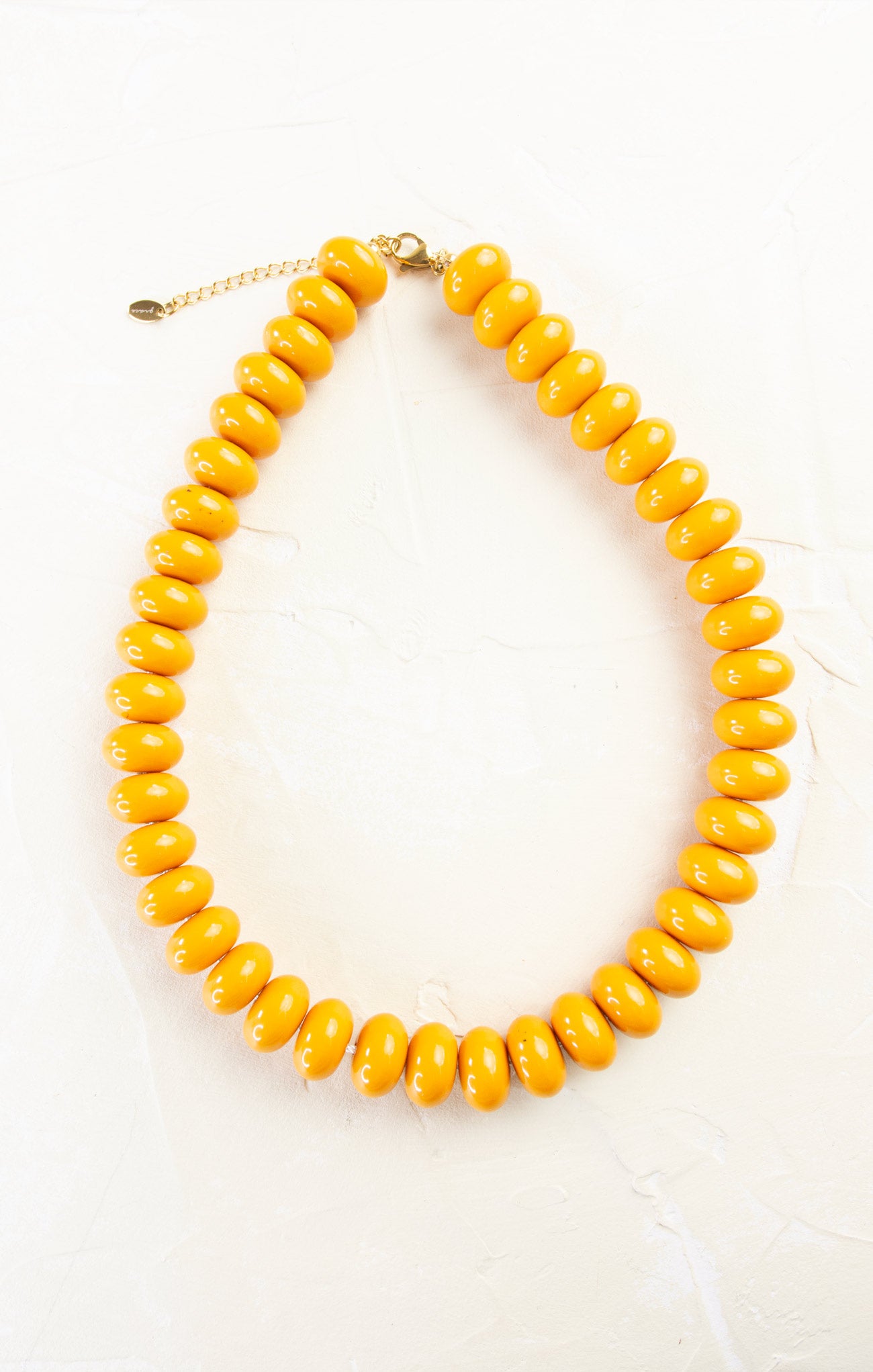 Yellow beaded necklace on a white background