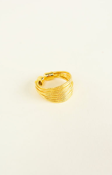 Gold ring on a light beige background
