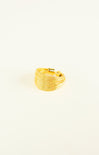 Gold ring with a textured design on a white background