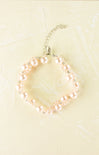 Pearl necklace on a light beige background
